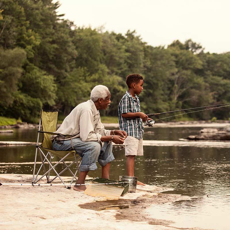 Grandfather and grandchild fishing during retirement