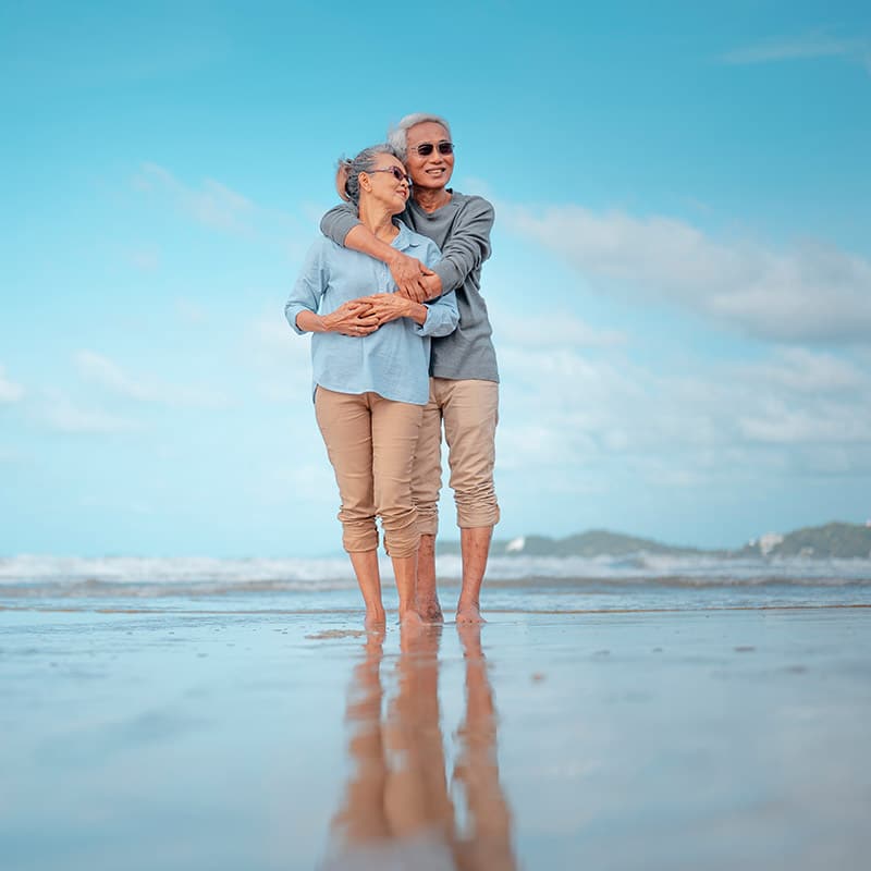 Retired couple enjoying vacation on beach