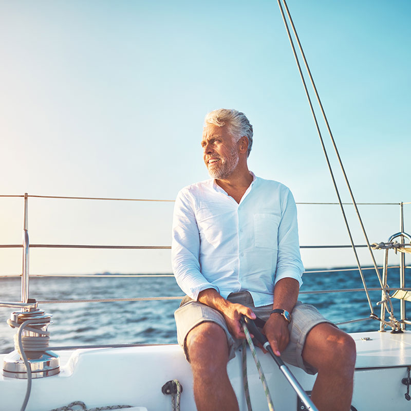 senior-man-sailing man enjoying his retirement sailing